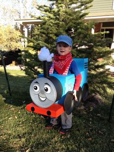 a little boy in a thomas the tank engine costume