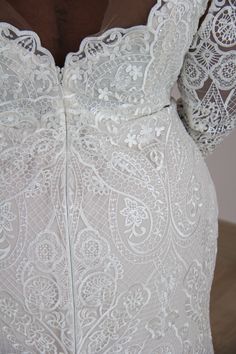 the back of a woman's dress with white lace on it