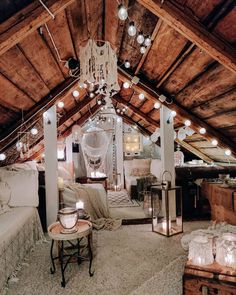 a bedroom with wooden beams and lights hanging from the ceiling