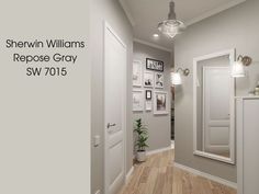 a hallway with white walls and wood flooring next to a mirror on the wall