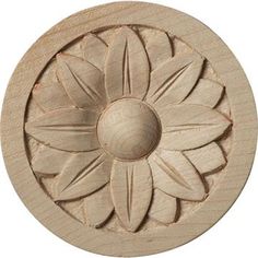 a carved wooden flower on a white background