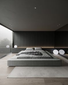 an image of a bed in the middle of a room with black and white decor