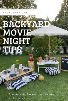 backyard movie night tips with an picnic table and white umbrella in the back yard area