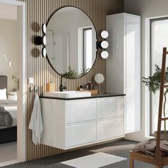 a bathroom with a sink, mirror and chair