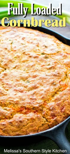 a close up of a baked cornbread in a skillet on a green cloth