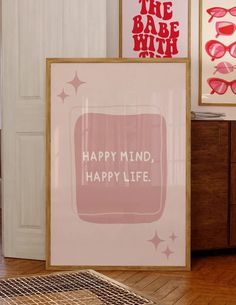 there are three framed pictures on the wall next to each other, and one is saying happy mind