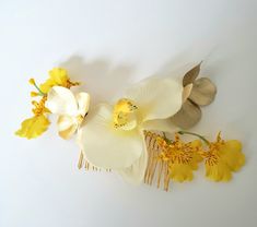 Wedding Hair comb tropical white yellow orchid with gold accents.  Elegant simplicity bridal prom headpiece destination wedding.  Handmade in the USA! Pretty baby shower or photo prop accessory on a gold metal comb.  Size: comb itself is about 3".  The total floral arrangement on the comb is about 4 1/2" long. Quality silk flowers with a cream-yellow phalanapsis orchid, tiny yellow sprays that are oncidium orchids and 2 metallic gold blossoms. Bridesmaid, bridal,  music festival, destination wedding headpiece.  Custom color requests and quantity orders accepted.  This listing is for one red hair comb. Contact me thru Etsy conversations or my direct email, Michele at AmoreBrideB@gmail.com More creative hair combs in my link: https://www.etsy.com/shop/AmoreBride?ref=seller-platform-mcnav&sec Tropical Wedding Hair, Orchid Yellow, Prom Headpiece, Flowers Headpiece, Destination Wedding Flowers, Oncidium Orchids, Luo Binghe, Headpiece Accessories, Yellow Orchid