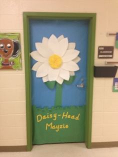 a door decorated with paper flowers and the words daisy - head mayzie