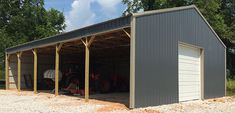 a large metal garage with two doors open