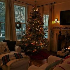 a living room with a christmas tree in the corner