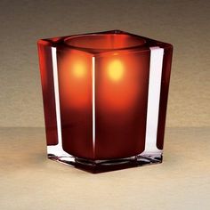 a candle that is sitting in the middle of some kind of glass container on a table