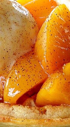 some oranges are sitting in a bowl with brown stuff on them and sprinkled