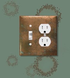 an old light switch and outlet cover on a green wall