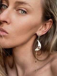 ALL THE MOONCHILDREN COLLECTION: Our Luminaries Dangle Earrings are gold-filled and feature one hand carved white moonstone and one hand carved peach moonstone both set in FINE SILVER bezels. They feature gold filled large crescent moons, little stars, and starburst chain, gold filled earring posts, and 14k gold earring backs. In total they are 4.75 inches in length. Silversmithing is an incredibly labor intensive process. A stone is selected and an entire design is formulated around its unique Unique Moon Charm Drop Earrings, Gold Moonstone Earrings With Moon Phase Detail, Moon Gold, Kids Earrings, Gold Filled Earrings, Earring Backs, Crescent Moon, Post Earrings, Crescent