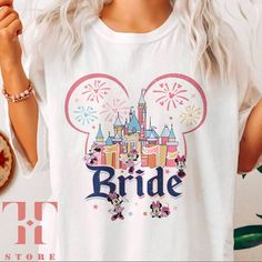 a woman wearing a white tshirt with the word bride in front of a castle