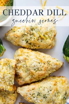 cheddar dill biscuits with cheese and herbs on top, next to broccoli