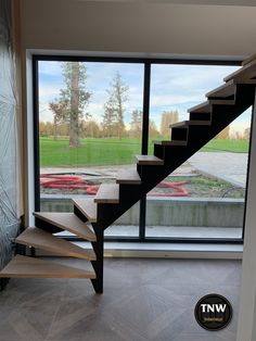 a staircase in front of a large glass window