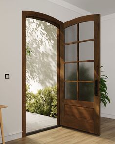 an open door to a patio with a potted plant