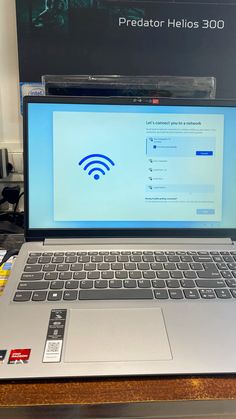 an open laptop computer sitting on top of a wooden desk