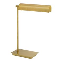 a gold desk lamp on a white background