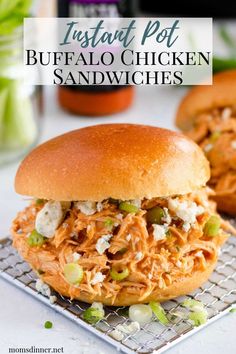 a close up of a sandwich on a cooling rack with the words instant pot buffalo chicken sandwiches