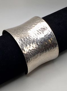 This is a wide handcrafted Sterling Silver Concave Hammered Solid Cuff Bracelet.  Very special design is the perfect example of when simple can be bold. Good pre-own vintage condition. Stamped "925" mark inside the bracelet. Inner Length: 5 9/16" (14 cm).      The Bangle is Adjustable in Size  Cuff bracelet width: 4.5 cm;   Opening: 1" (2.5 cm) Weight: 48 grams  Item is exactly as shown in pictures.    Please carefully review the item description and accompanying pictures before making a purchase, as we do not offer a return or exchange policy. If you have any questions or require assistance, please do not hesitate to reach out to us.  Check my store link to find more treasures:   https://galaxysilvercity.etsy.com Handmade Silver Wide Band Bangle, Silver Wide Band Sterling Silver Bracelet As Gift, Sterling Silver Wide Band Bracelet Gift, Silver Wide Band Bracelet Gift, Silver Wide Band Bracelet As Gift, Silver Hammered Cuff Bracelet For Formal Occasions, Sterling Silver Wide Band Bracelet, Formal Hammered Silver Cuff Bracelet, Formal Silver Hammered Cuff Bracelet