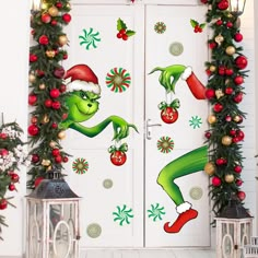 the grinch door is decorated with christmas decorations and garlands, along with holiday lights