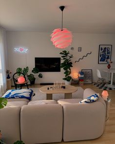 a living room filled with furniture and a flat screen tv mounted to the side of a wall