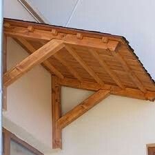 the corner of a building with a wooden roof