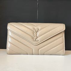 Beige Colored Ysl Saint Laurent Large Flap Wallet. Used This Wallet For Many Years And Still In Great Condition. There Is A Little Wear On The Back And On The Inside (As Shown In Pictures), But Otherwise It Is In Good Condition! Bags Ysl, Ysl Saint Laurent, Saint Laurent Bags, Yves Saint Laurent Bags, Yves Saint Laurent, Wallets, Saint Laurent, Bag Lady, Wallet