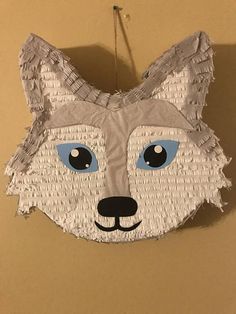 a piece of paper that has been made to look like a fox with blue eyes