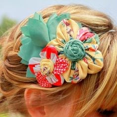 a close up of a child's head wearing a flowered hair clip in her hair