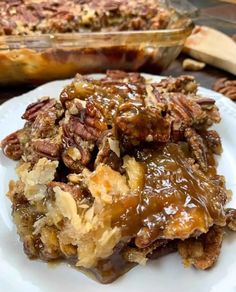 a close up of a plate of food with pecans on it and another dish in the background