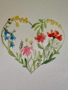 a heart shaped painting with flowers painted on it