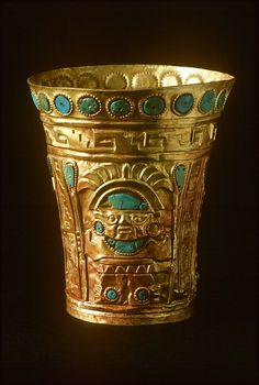 a gold cup with designs on it