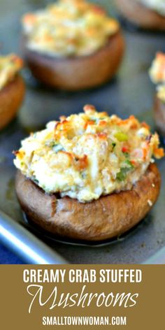 an image of crab stuffed mushrooms on a baking sheet with text overlay that reads creamy crab stuffed mushrooms