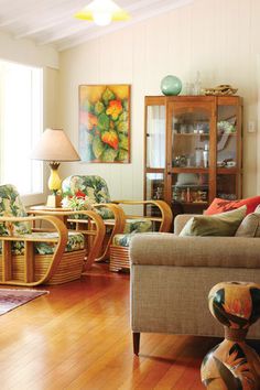 a living room filled with lots of furniture and decor on top of hard wood floors