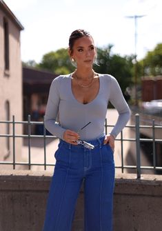 Slate Chic Long Sleeve Bodysuit With Thumbholes, Chic Fall Bodysuit With Thumbholes, Trendy Stretch Bodysuit For Workwear, Summer Long Sleeve Bodysuit For Workwear, Spring Bodysuit With Thumbholes, Chic Bodysuit With Thumbholes, Spring Chic Bodysuit With Thumbholes, Chic Spring Bodysuit With Thumbholes, Trendy Bodysuit With Thumbholes For Spring