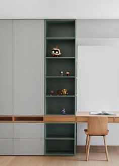 an office with shelves, desk and chair in the middle of it is painted gray