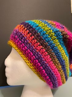 Beautiful colorful striped slouchy beanie. A very attractive  chunky yarn that is so colorful and soft. If you like colorful then this is the hat for you. It's fashionable, warm and looks great on. This hat will most probably match any outfit. The hat circumference is 20 inches around. Measures 8.5 inches long from the crown. Created in a soft acrylic yarn that is easy to care for. Machine wash on gentle in cold water. Reshape and lay flat to dry. Created in a smoke free environment and always handmade with love. Slouchy Hats, Slouchy Hat, Slouchy Beanie, Crochet Hat Pattern, Chunky Yarn, Hat Pattern, The Crown, Hand Crochet, Acrylic Yarn