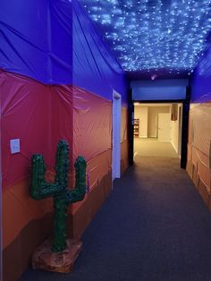 a long hallway is decorated with blue lights