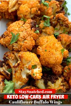 a white plate topped with cauliflower covered in parsley next to a pile of wings