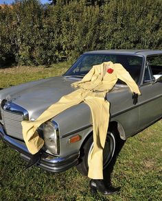 an old car with a cloth draped over it