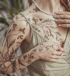 a woman with tattoos on her arms and chest