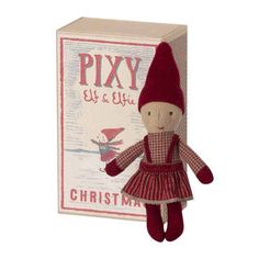 a red and white stuffed toy in front of a box with the word pix on it