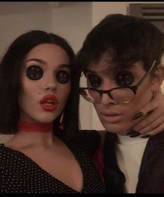 a man and woman are dressed up for halloween with fake eyeballs on their faces