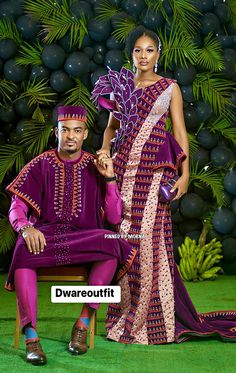 a man and woman dressed in african clothing