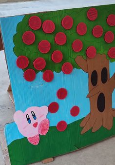 an art project made out of cardboard with red circles on it and a cartoon tree