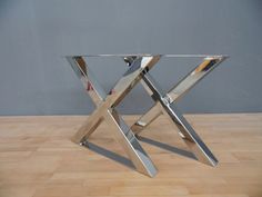 a metal table sitting on top of a wooden floor