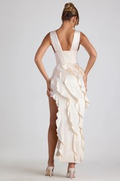 Dreamy RSVPs await. A design that’s sure to turn heads, the Ambrosia dress is crafted from sumptuous matte satin with a touch of stretch and rendered in a timeless ivory hue. Cut to a maxi length with a plunging V-neckline and boned corset bodice, the fitted column silhouette is enlivened with diagonal ruffle trims and a thigh-high split that creates a dynamic sense of movement.  Plunge V-neck   Wide shoulder straps   Decorative boned waist corset   Pleat detailing   Diagonal frill trims   Thigh Corset Maxi Dress, Side Split Maxi Dress, Velvet Prom Dress, Waist Corset, Black Tie Gala, Garden Party Dress, Corset Bodice, Split Maxi Dress, Split Dress